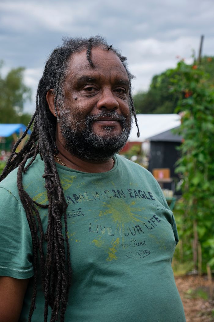 Verified professional gardener trimming a hedge